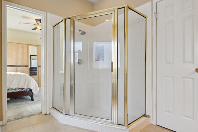 ensuite bathroom with a shower stall, tile patterned floors, ensuite bathroom, and ceiling fan