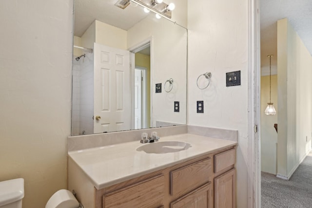 bathroom featuring toilet and vanity