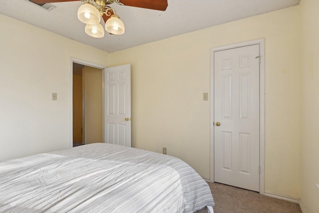 bedroom with a ceiling fan, light colored carpet, and visible vents