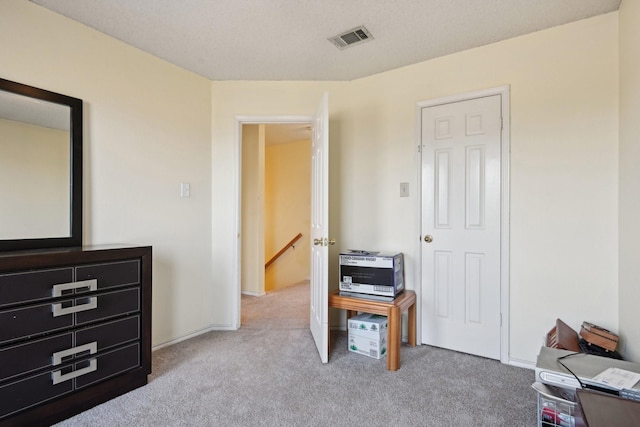 carpeted bedroom featuring visible vents and baseboards