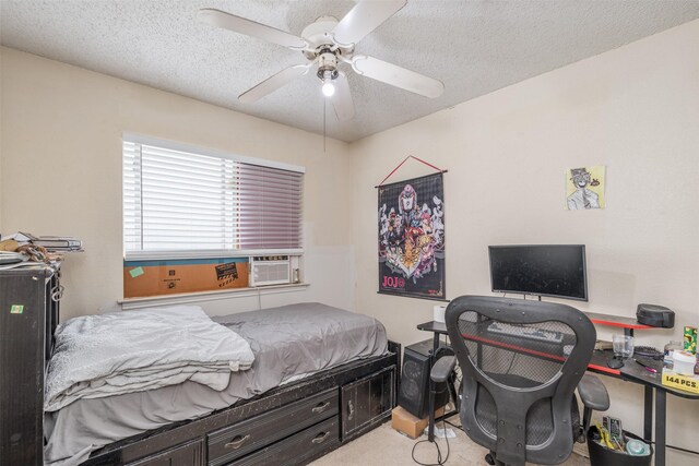 bedroom featuring cooling unit, a textured ceiling, a ceiling fan, and carpet floors