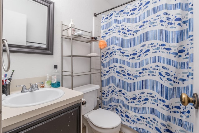 bathroom with vanity, curtained shower, and toilet