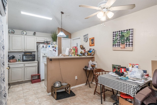 dining space with a ceiling fan, a textured ceiling, light tile patterned flooring, a toaster, and lofted ceiling