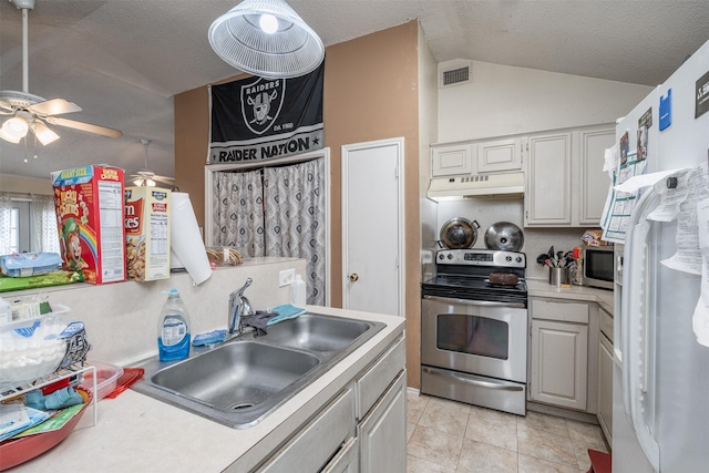 kitchen featuring lofted ceiling, ceiling fan, a sink, under cabinet range hood, and appliances with stainless steel finishes