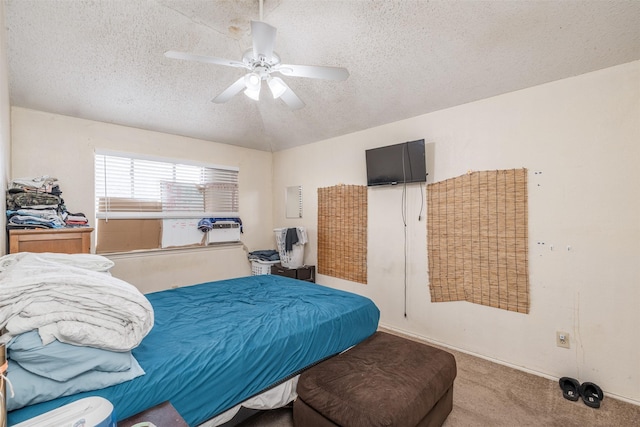 carpeted bedroom with a textured ceiling and ceiling fan