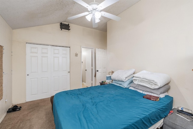 bedroom featuring ceiling fan, vaulted ceiling, carpet flooring, a closet, and a textured ceiling