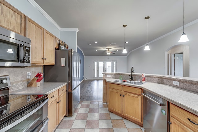 kitchen with tasteful backsplash, appliances with stainless steel finishes, a sink, and ornamental molding