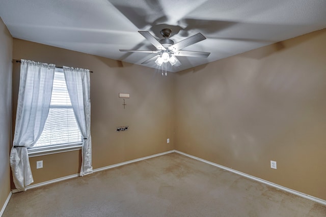 unfurnished room with ceiling fan, baseboards, and light colored carpet