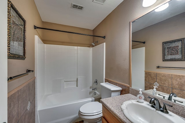 full bathroom featuring bathtub / shower combination, visible vents, vanity, and toilet