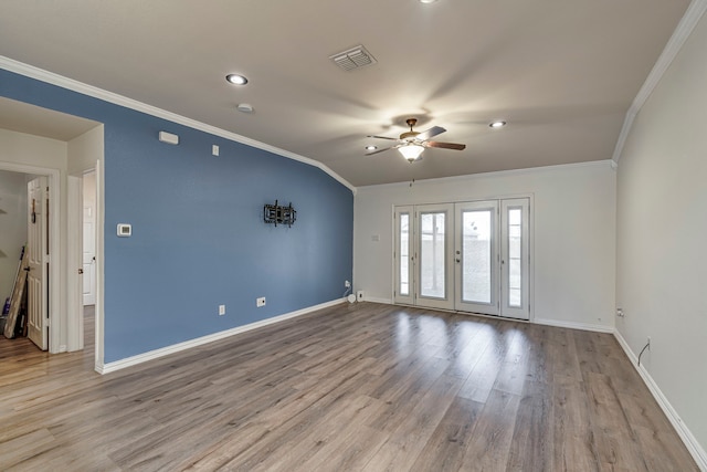 unfurnished room with visible vents, crown molding, baseboards, and wood finished floors