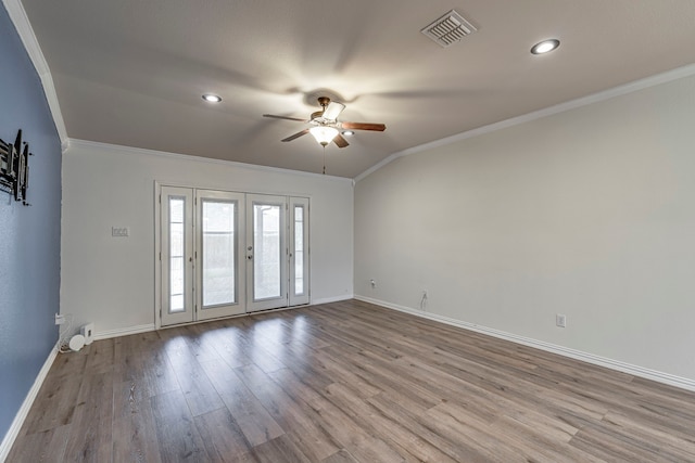 unfurnished room with visible vents, wood finished floors, crown molding, and french doors