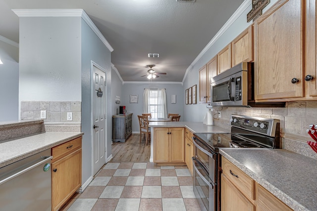 kitchen featuring a peninsula, ornamental molding, appliances with stainless steel finishes, light brown cabinetry, and tasteful backsplash