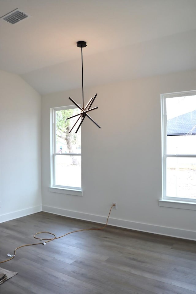 empty room with plenty of natural light, visible vents, and baseboards