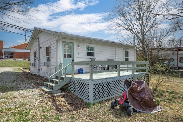 rear view of property with cooling unit and a wooden deck