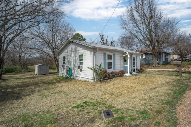 exterior space with a storage unit, a front lawn, and an outdoor structure