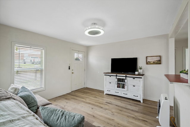 living room featuring light wood-style flooring and baseboards