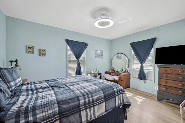 bedroom featuring light wood-type flooring and baseboards