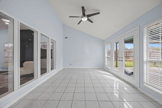 unfurnished sunroom featuring lofted ceiling, ceiling fan, a wealth of natural light, and french doors