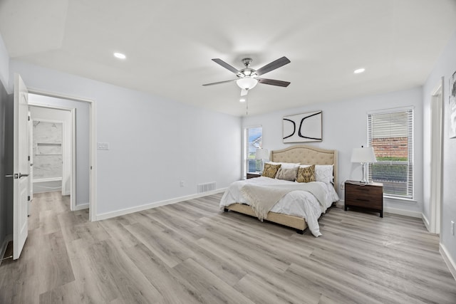 bedroom with visible vents, light wood-style flooring, and baseboards