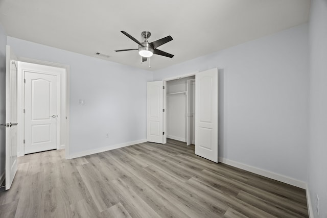 unfurnished bedroom with light wood-style flooring, a closet, visible vents, and baseboards