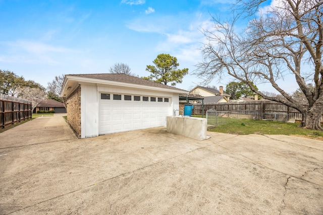 detached garage featuring fence