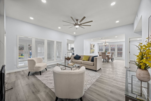 living room with french doors, light wood-type flooring, and recessed lighting