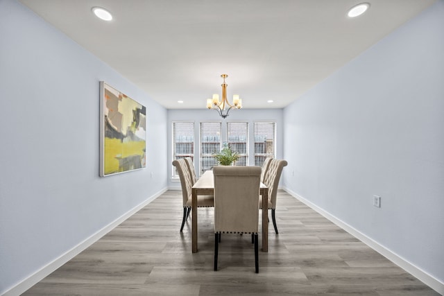 dining area with recessed lighting, a notable chandelier, baseboards, and wood finished floors