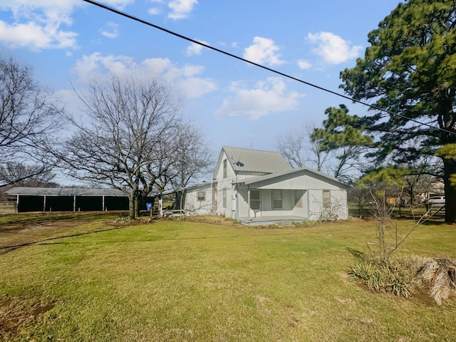 view of side of home featuring a yard