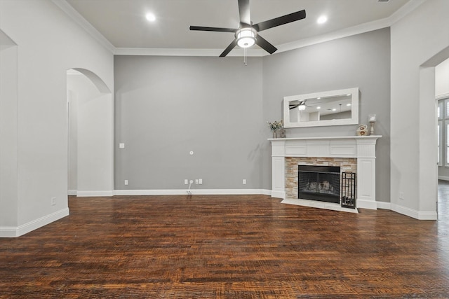 unfurnished living room featuring baseboards, crown molding, ceiling fan, and wood finished floors