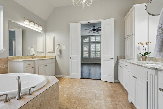 bathroom featuring tile patterned floors, a bath, lofted ceiling, and a sink