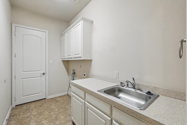 laundry area with hookup for a washing machine, baseboards, hookup for an electric dryer, cabinet space, and a sink