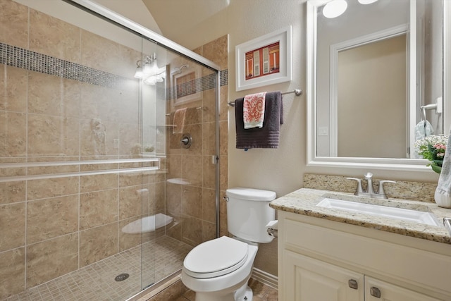 full bath featuring a shower stall, toilet, and vanity