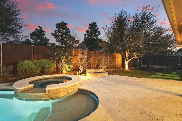 view of pool featuring a patio area, a fenced backyard, a fenced in pool, and an in ground hot tub