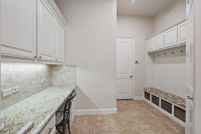 mudroom featuring light tile patterned flooring and baseboards