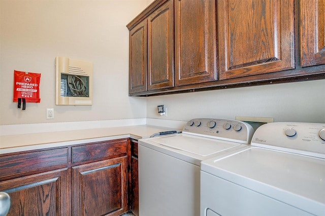 laundry area featuring washing machine and clothes dryer and cabinet space