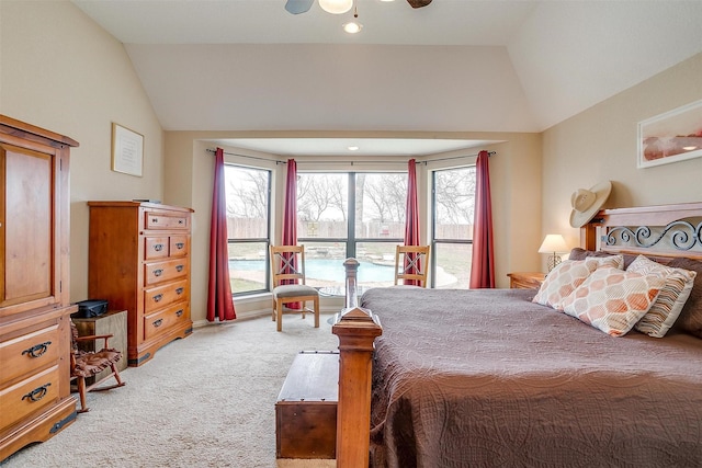 bedroom with lofted ceiling, light colored carpet, and multiple windows