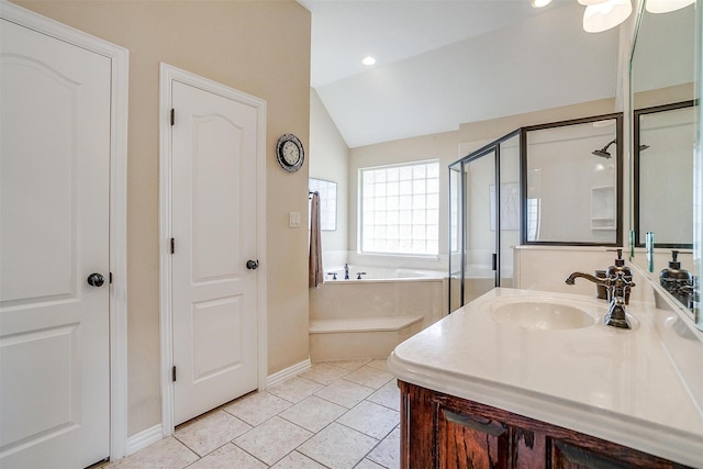 bathroom with a stall shower, tile patterned floors, a garden tub, vaulted ceiling, and vanity