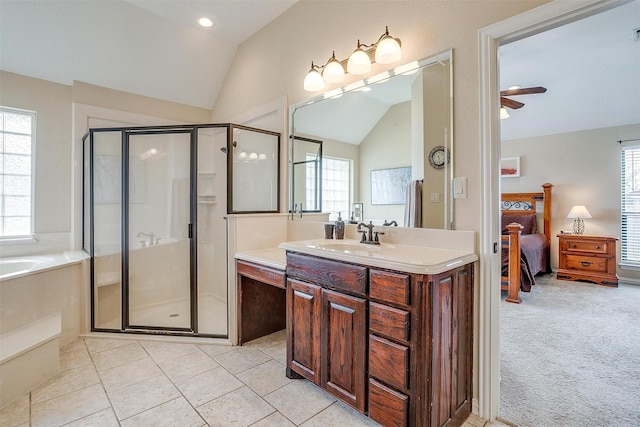 ensuite bathroom with a garden tub, a stall shower, vaulted ceiling, vanity, and ensuite bath