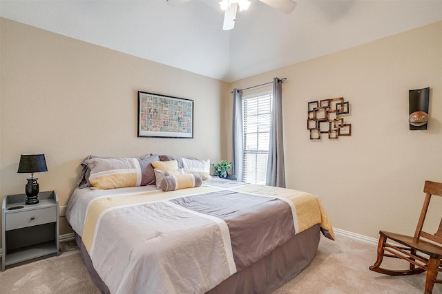 bedroom with light carpet, baseboards, vaulted ceiling, and a ceiling fan