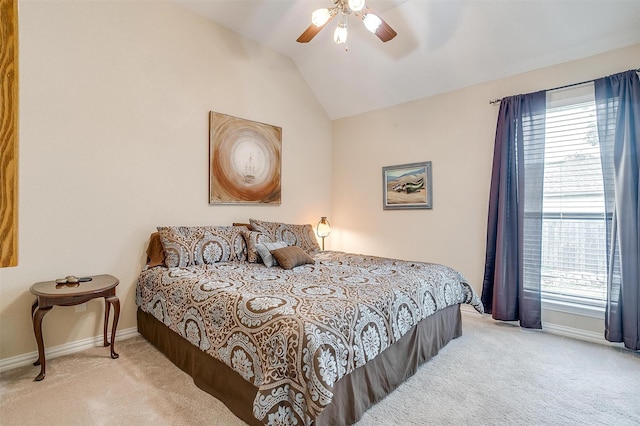 bedroom featuring carpet floors, baseboards, vaulted ceiling, and a ceiling fan