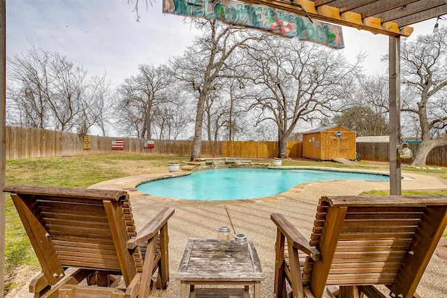 view of pool with a fenced backyard, an outdoor structure, a yard, a fenced in pool, and a storage unit