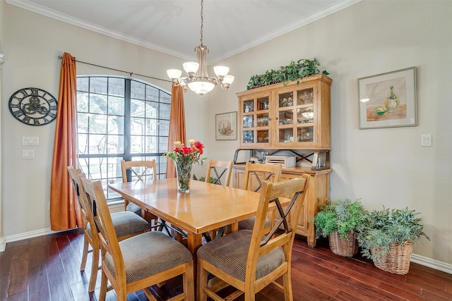 dining area with dark wood-type flooring, ornamental molding, and baseboards