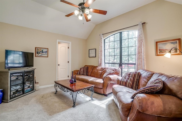 carpeted living area with vaulted ceiling, a ceiling fan, and baseboards