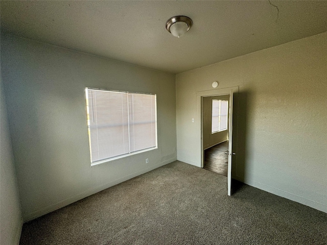 unfurnished bedroom featuring carpet floors and baseboards