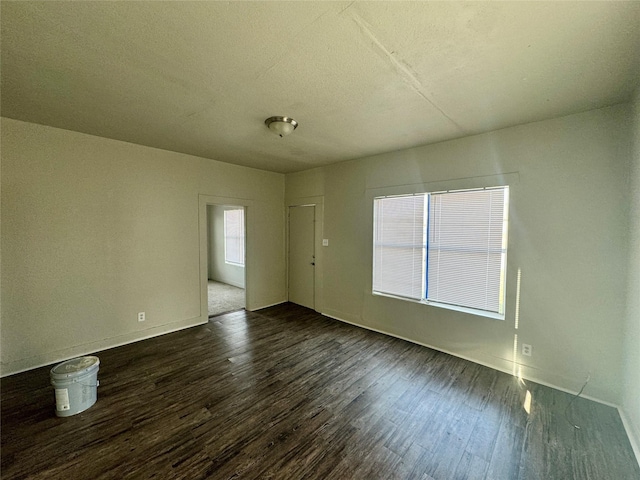 unfurnished room featuring dark wood finished floors