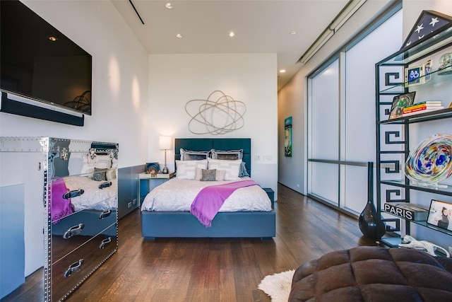 bedroom featuring wood finished floors and recessed lighting