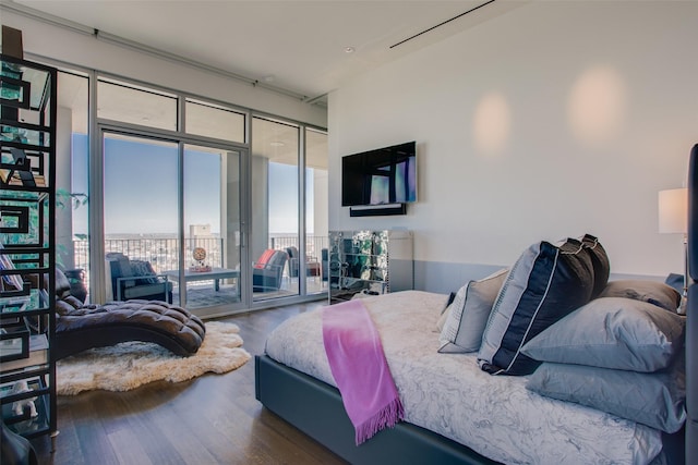 bedroom with wood finished floors and access to exterior