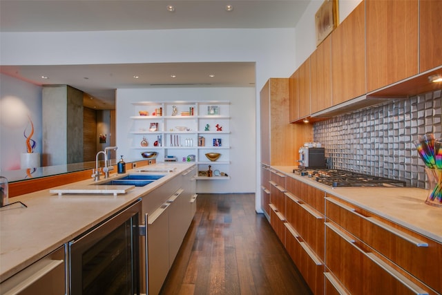 kitchen featuring beverage cooler, decorative backsplash, dark wood finished floors, modern cabinets, and a sink