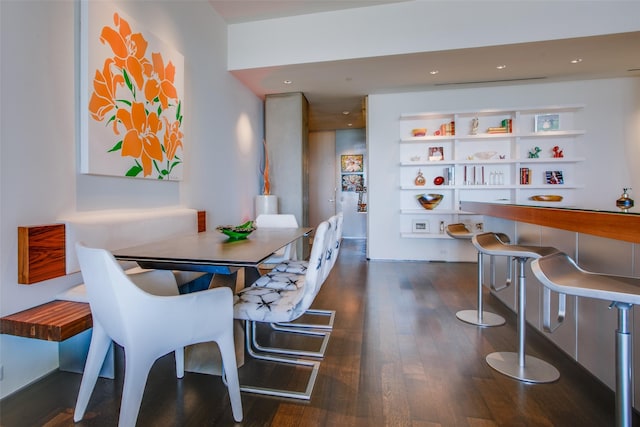 dining area featuring built in features, recessed lighting, and dark wood-style flooring