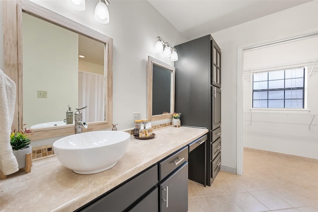 full bathroom with tile patterned flooring, vanity, and baseboards